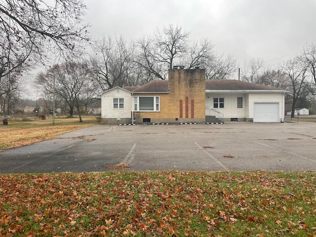 back of property featuring a garage