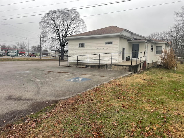 view of side of home with a yard