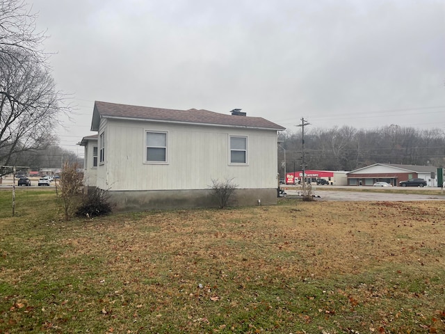 view of side of property with a lawn