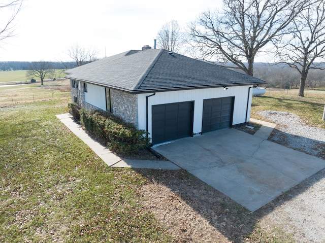 view of property exterior featuring a rural view, a garage, and a lawn