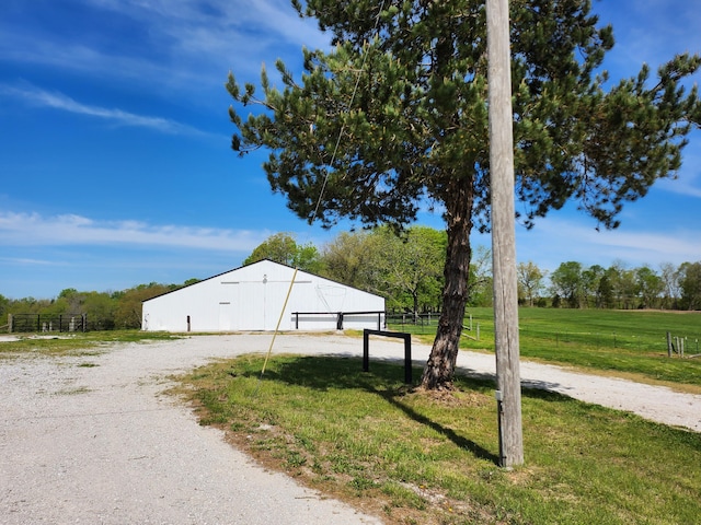 view of home's exterior featuring a yard and a rural view