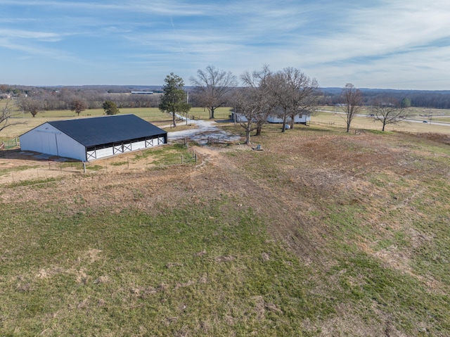 view of yard with a rural view and an outdoor structure