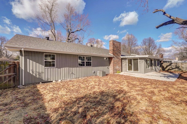 back of property featuring a sunroom, central air condition unit, and a patio