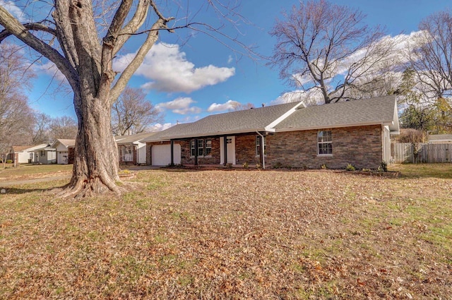 back of house with a lawn and a garage