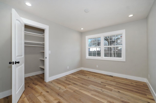 unfurnished bedroom with a closet and light hardwood / wood-style flooring