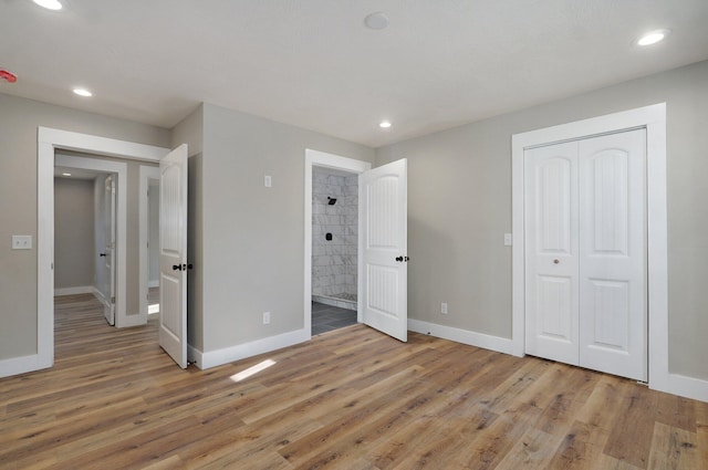 unfurnished bedroom featuring a closet and light wood-type flooring