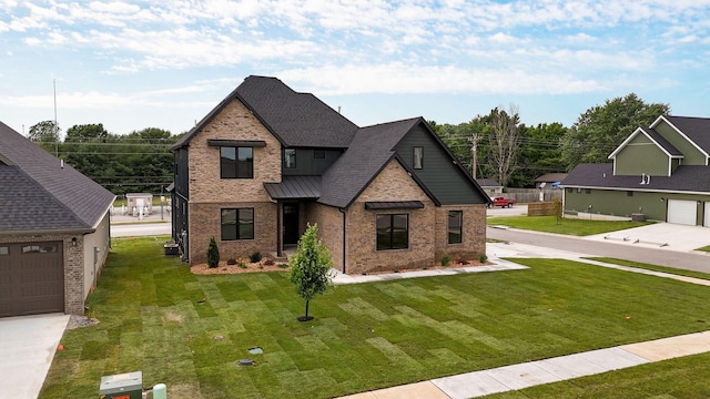 view of front of house featuring a garage and a front lawn