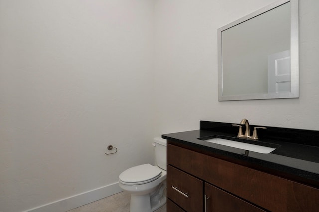 bathroom with tile patterned floors, vanity, and toilet