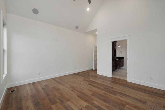 spare room featuring ceiling fan, hardwood / wood-style flooring, and high vaulted ceiling