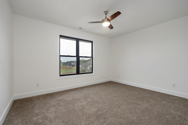 unfurnished room featuring ceiling fan and carpet