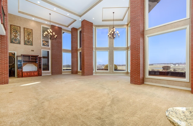 20478 Lawrence Unit 2180, Aurora, MO 65605 - unfurnished living room with a high ceiling, a notable chandelier, carpet flooring, and recessed lighting