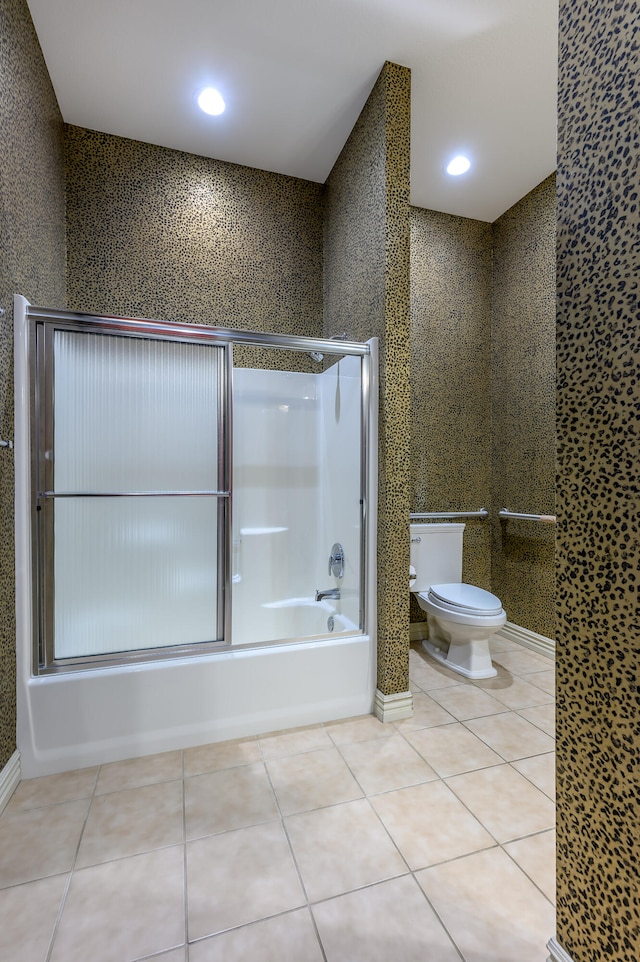 bathroom with shower / bath combination with glass door, toilet, and tile patterned floors