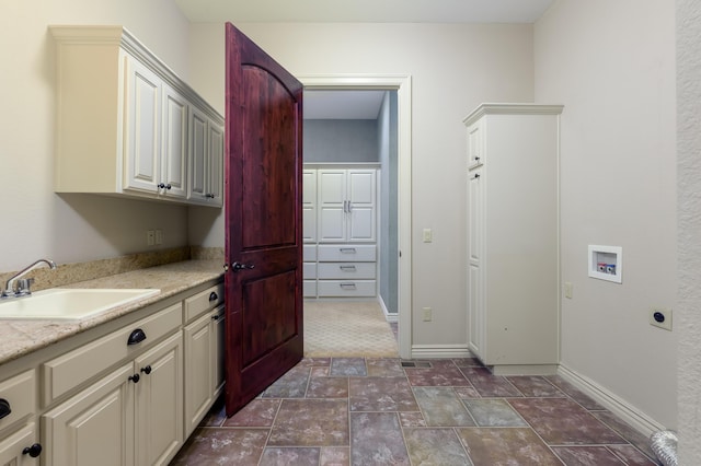 20478 Lawrence Unit 2180, Aurora, MO 65605 - laundry room with hookup for a washing machine, a sink, electric dryer hookup, cabinet space, and baseboards