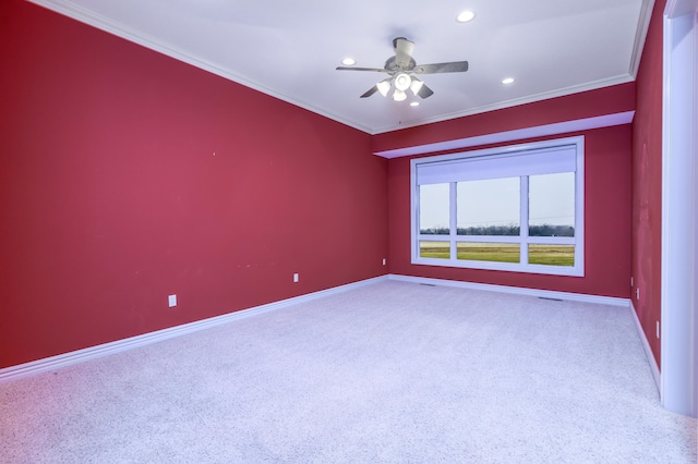 unfurnished room with ceiling fan, carpet floors, and crown molding