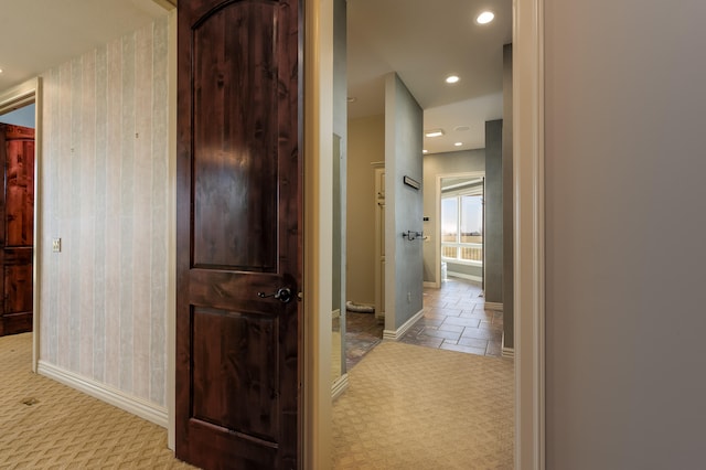 hall featuring light colored carpet