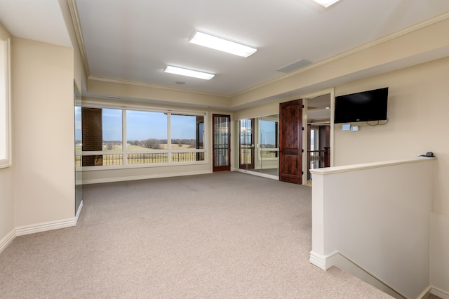 carpeted empty room featuring crown molding