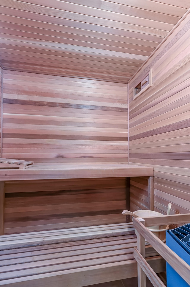 view of sauna / steam room with wooden walls and wooden ceiling