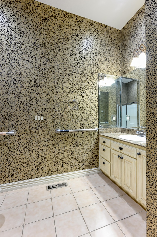 bathroom with tile patterned floors and vanity