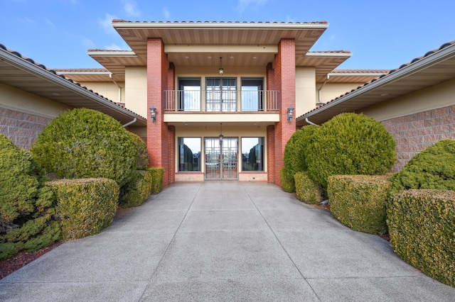 20478 Lawrence Unit 2180, Aurora, MO 65605 - property entrance with brick siding, french doors, and a balcony