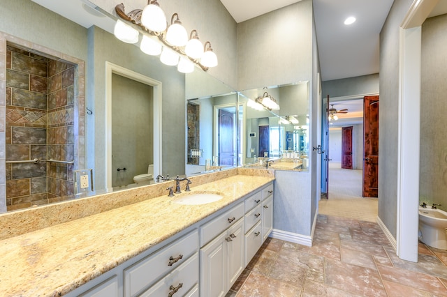 bathroom with a bidet, toilet, a shower, and vanity