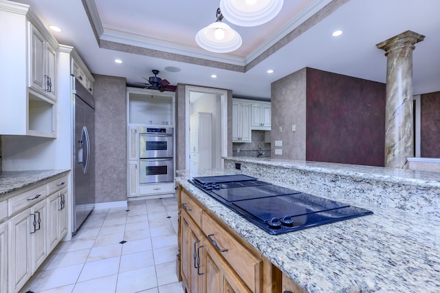 20478 Lawrence Unit 2180, Aurora, MO 65605 - kitchen featuring a tray ceiling, ornate columns, ceiling fan, crown molding, and appliances with stainless steel finishes
