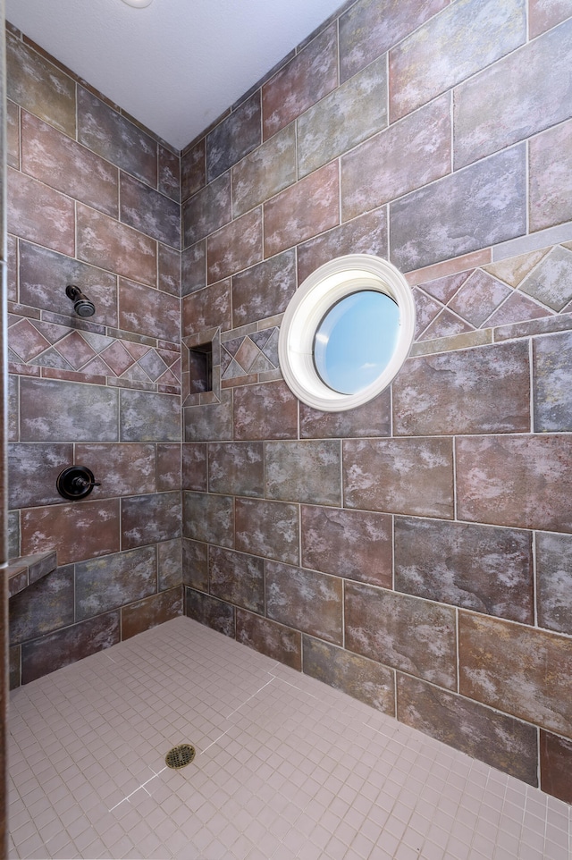 bathroom with tiled shower