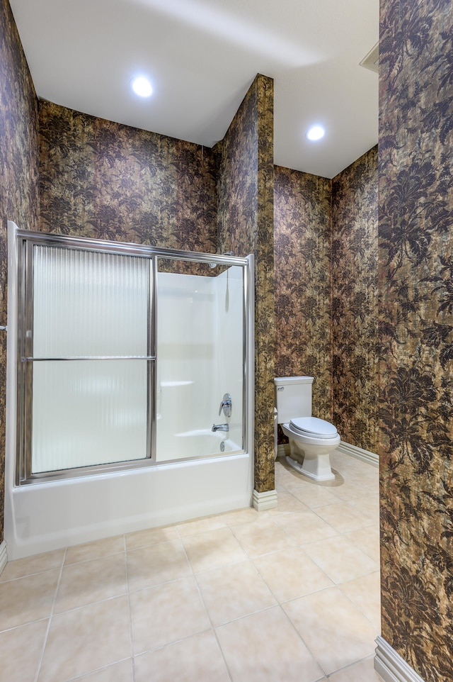 bathroom featuring bathing tub / shower combination, tile patterned flooring, and toilet