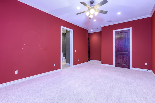 unfurnished bedroom with crown molding, carpet flooring, ensuite bathroom, and ceiling fan