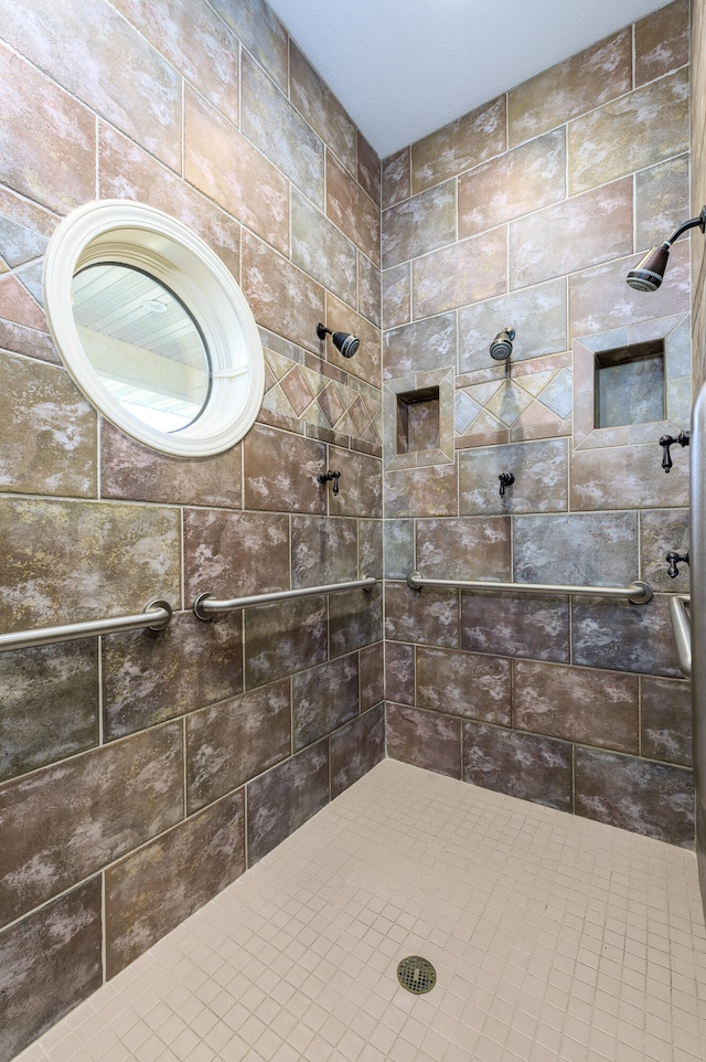 bathroom with tiled shower