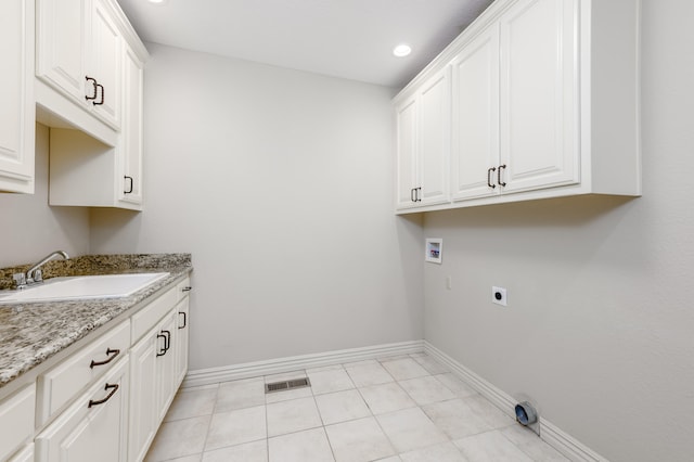 laundry area with light tile patterned floors, sink, cabinets, hookup for a washing machine, and electric dryer hookup