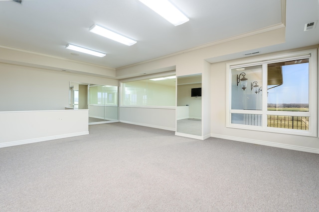 carpeted empty room with crown molding