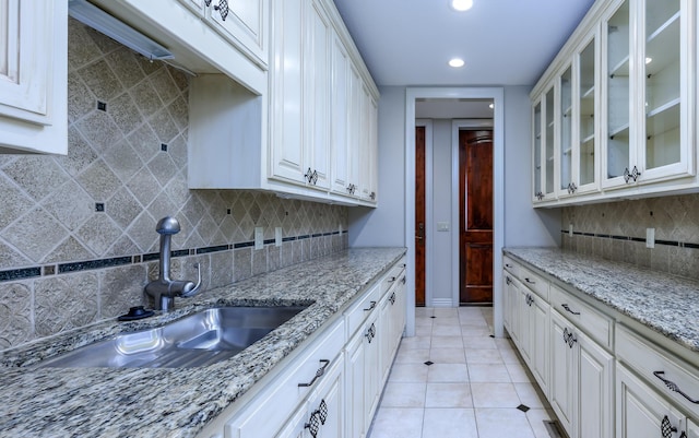 20478 Lawrence Unit 2180, Aurora, MO 65605 - kitchen featuring glass insert cabinets, backsplash, a sink, and recessed lighting