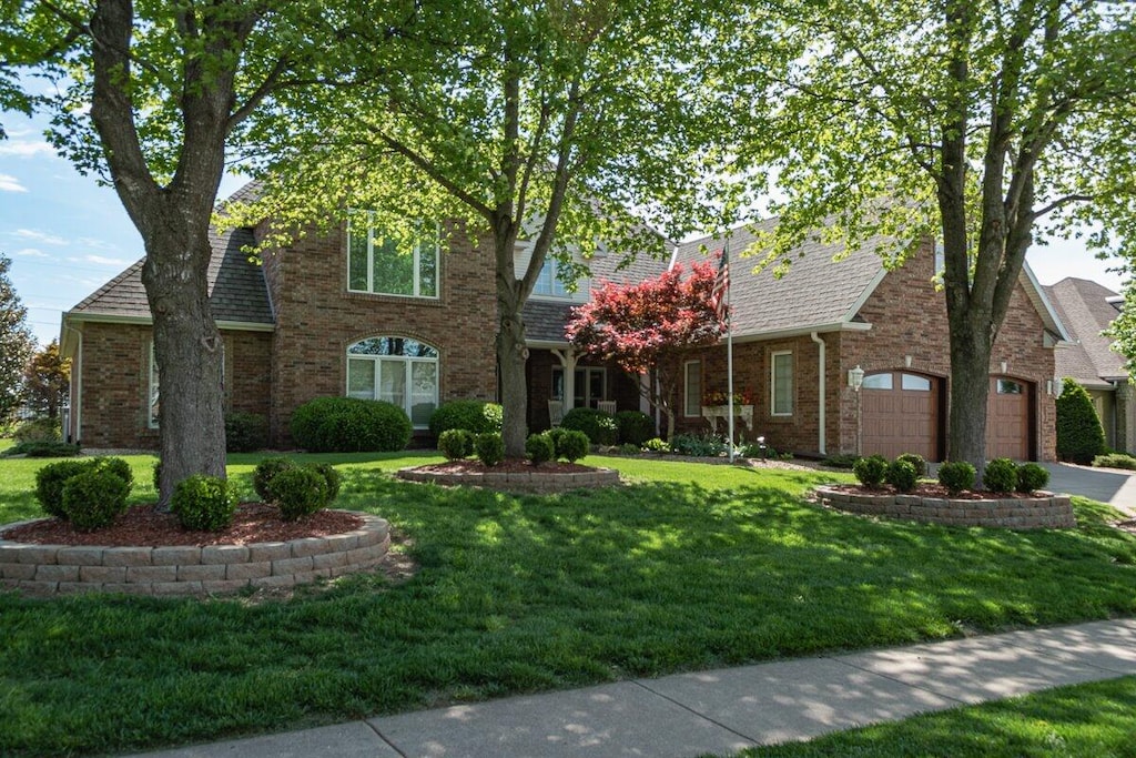 view of front facade with a front yard and a garage