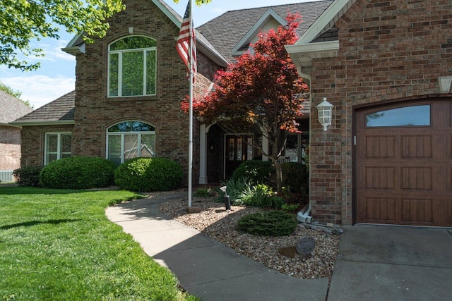 view of front of property with a garage and a front lawn