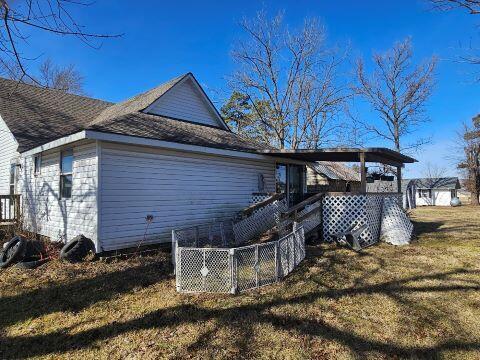 view of side of home featuring a lawn