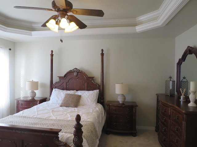 carpeted bedroom featuring ornamental molding, a raised ceiling, and ceiling fan