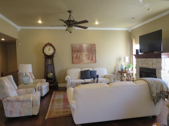 living room with ornamental molding, a stone fireplace, ceiling fan, and dark hardwood / wood-style flooring