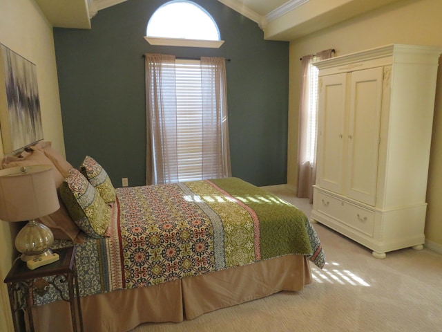 carpeted bedroom with crown molding and vaulted ceiling