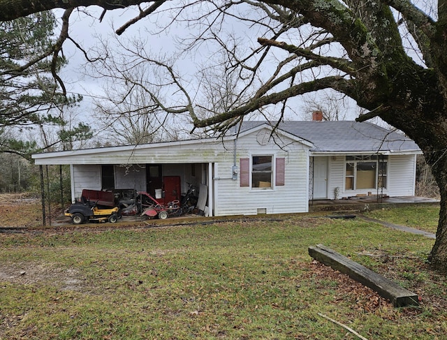 exterior space featuring a yard and a carport