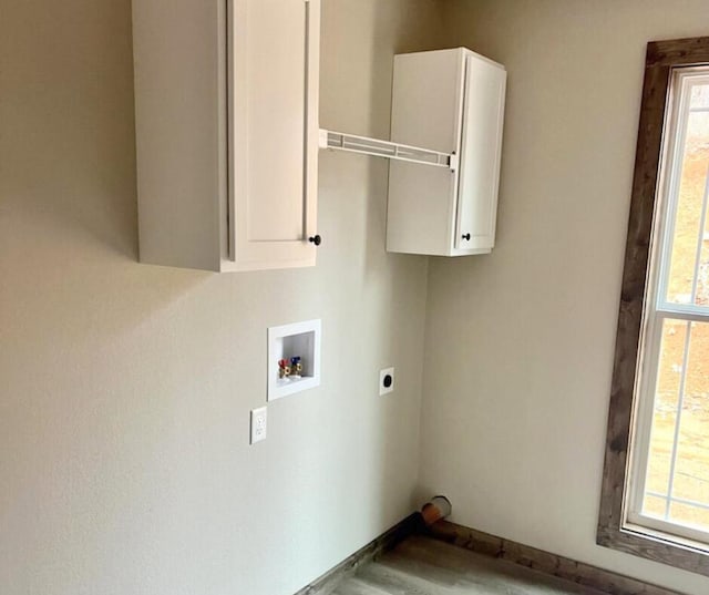 laundry area with cabinet space, washer hookup, wood finished floors, and electric dryer hookup