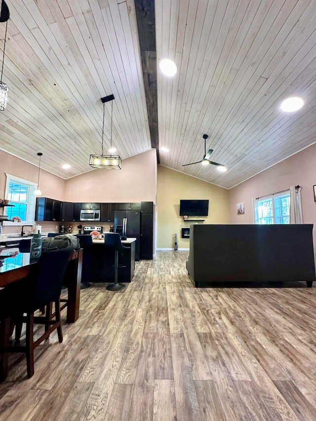 interior space with light wood-style floors, wooden ceiling, and vaulted ceiling