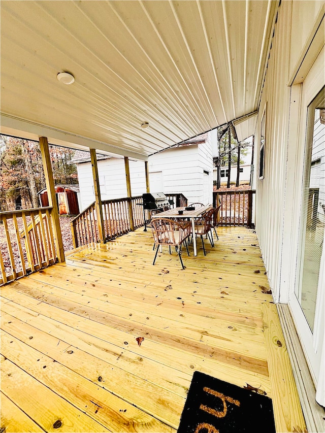 wooden terrace with outdoor dining area