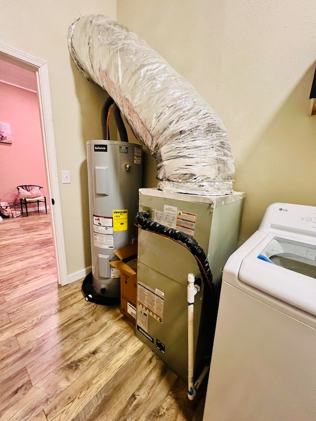 utility room featuring water heater and washer / clothes dryer