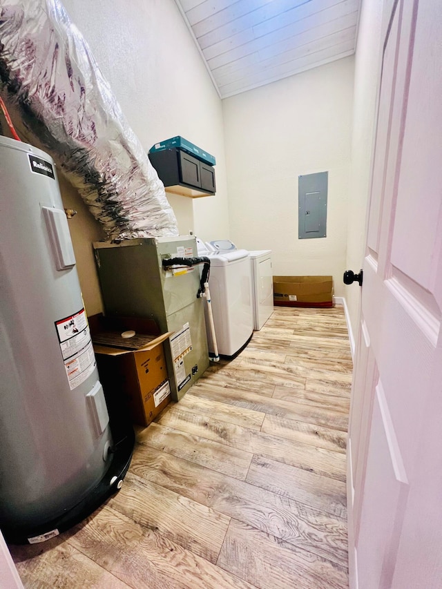 clothes washing area with electric water heater, laundry area, light wood-style floors, washer and dryer, and electric panel