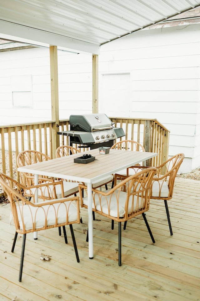 deck featuring outdoor dining area and area for grilling