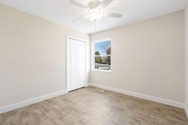 unfurnished bedroom with visible vents, baseboards, a ceiling fan, light wood-type flooring, and a closet