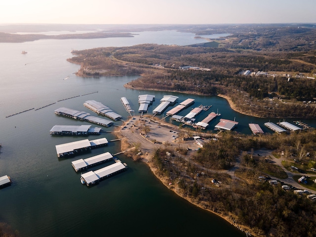 aerial view at dusk featuring a water view