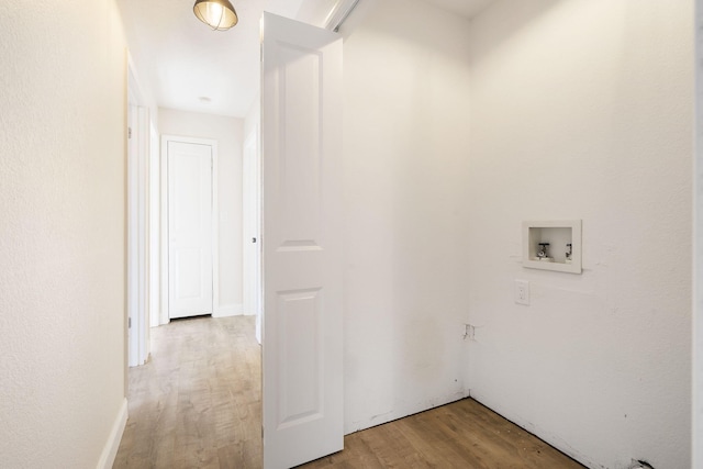 washroom with laundry area, hookup for a washing machine, and light wood-style floors