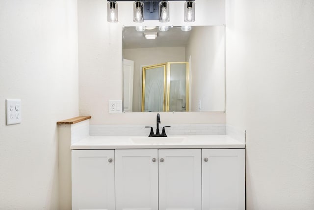 bathroom featuring a stall shower and vanity