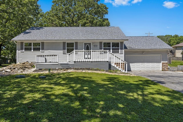 single story home featuring a front yard, a garage, and covered porch